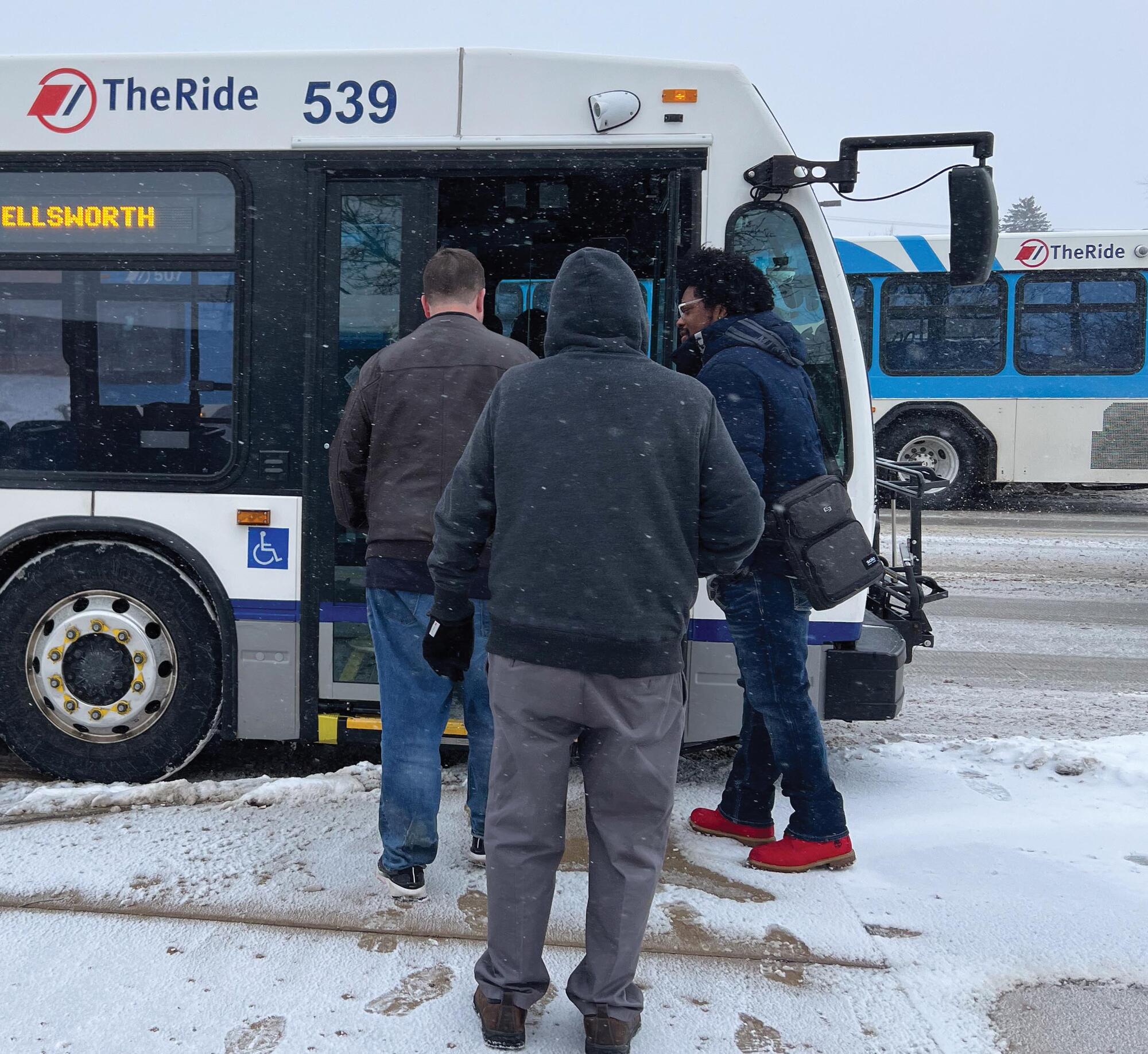 Photo of riders boarding bus in winter