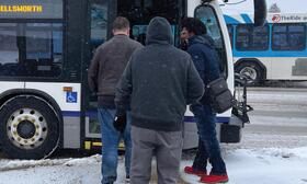 Photo of riders boarding bus in winter